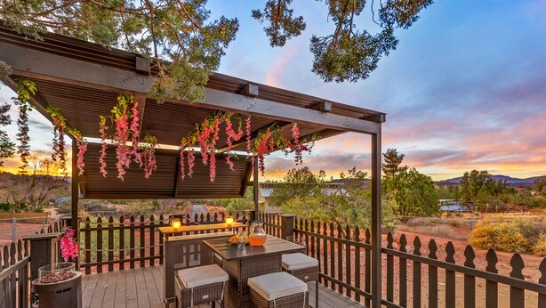 An outdoor patio with a pergola, seating, and a view of the landscape. - Serene Home ~ Sleeps 16 ~ Kings & Queens~ 2 Kitchens~ Hot Tub ~ Starlink Wifi (Sedona)