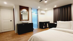 A hotel room with a bed, a desk, a mirror, and a window with curtains. - DAON HOTEL (Gimhae)