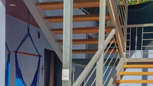 A staircase with wooden steps and a metal railing, leading to a door. - Private room for 2 people 26 km from Jaco (San Antonio de Tulín)