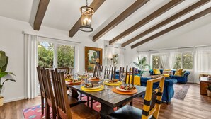 A dining area with a wooden table set for a meal, surrounded by chairs. - Large Spanish Villa ~ Sleeps 14~ Gym ~ GameRm~ Pool ~ Views  (Sedona)