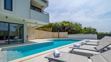 A heated pool, pool loungers