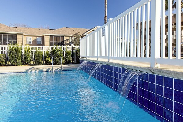 A swimming pool with a blue-tiled edge and a white fence. - Near Tropic Falls Water Park – Fun & Relaxation Await! (Foley)