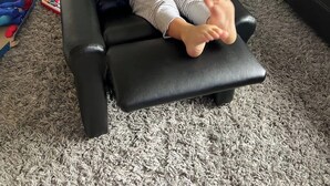 A child sitting on a black leather couch in a living room with a grey carpet. - Modern Home w/Gameroom near Airport Beaches Disney (Long Beach)