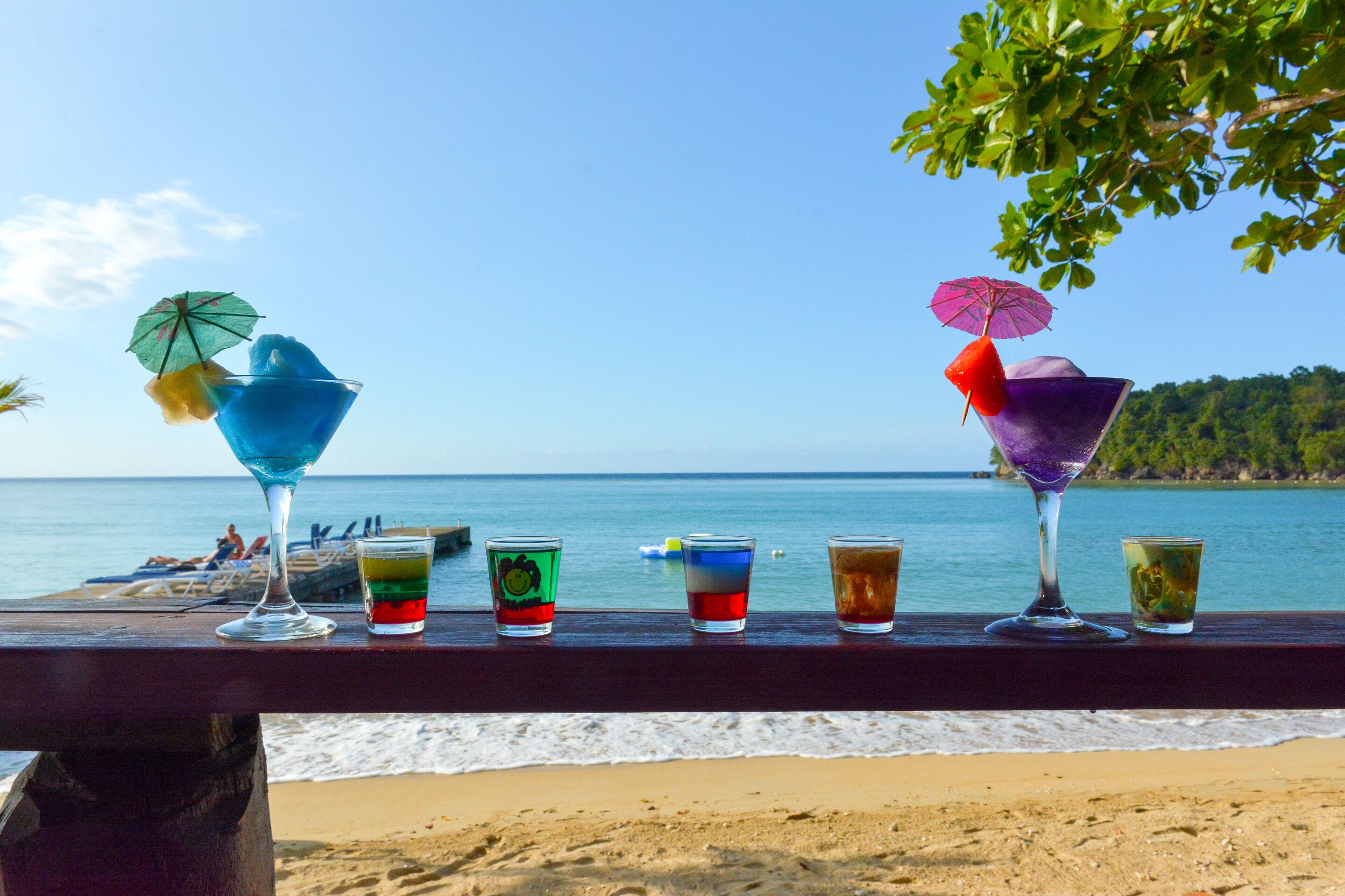 A beach view with a wooden railing.