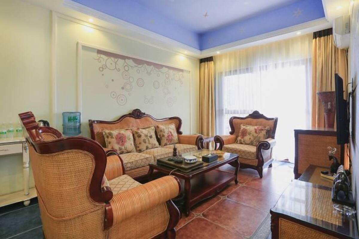 A living room with a sofa set, a coffee table, and a television.