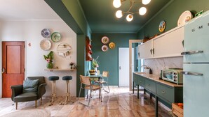 A kitchen with a green ceiling, a wooden door, and a vintage refrigerator. - Downtown Alegria (Tavira)