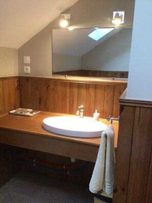 Bathtub, hair dryer, towels, toilet paper