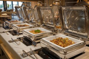 A buffet setup with multiple self-service stations, each with a clear glass cover and labeled with food options. - Moire Hoi An, Vignette Collection by IHG (Da Nang)