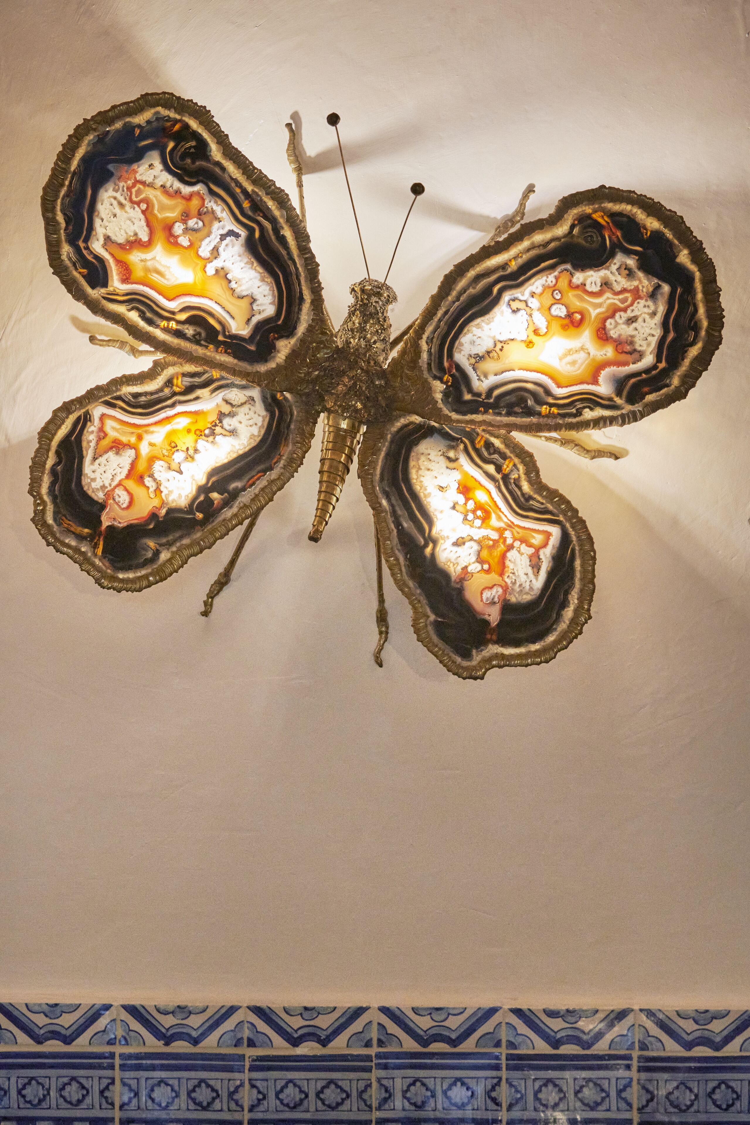 Eine Decke mit einer einzigartigen Kunstinstallation, die eine Schmetterling aus Achatsteinen darstellt.