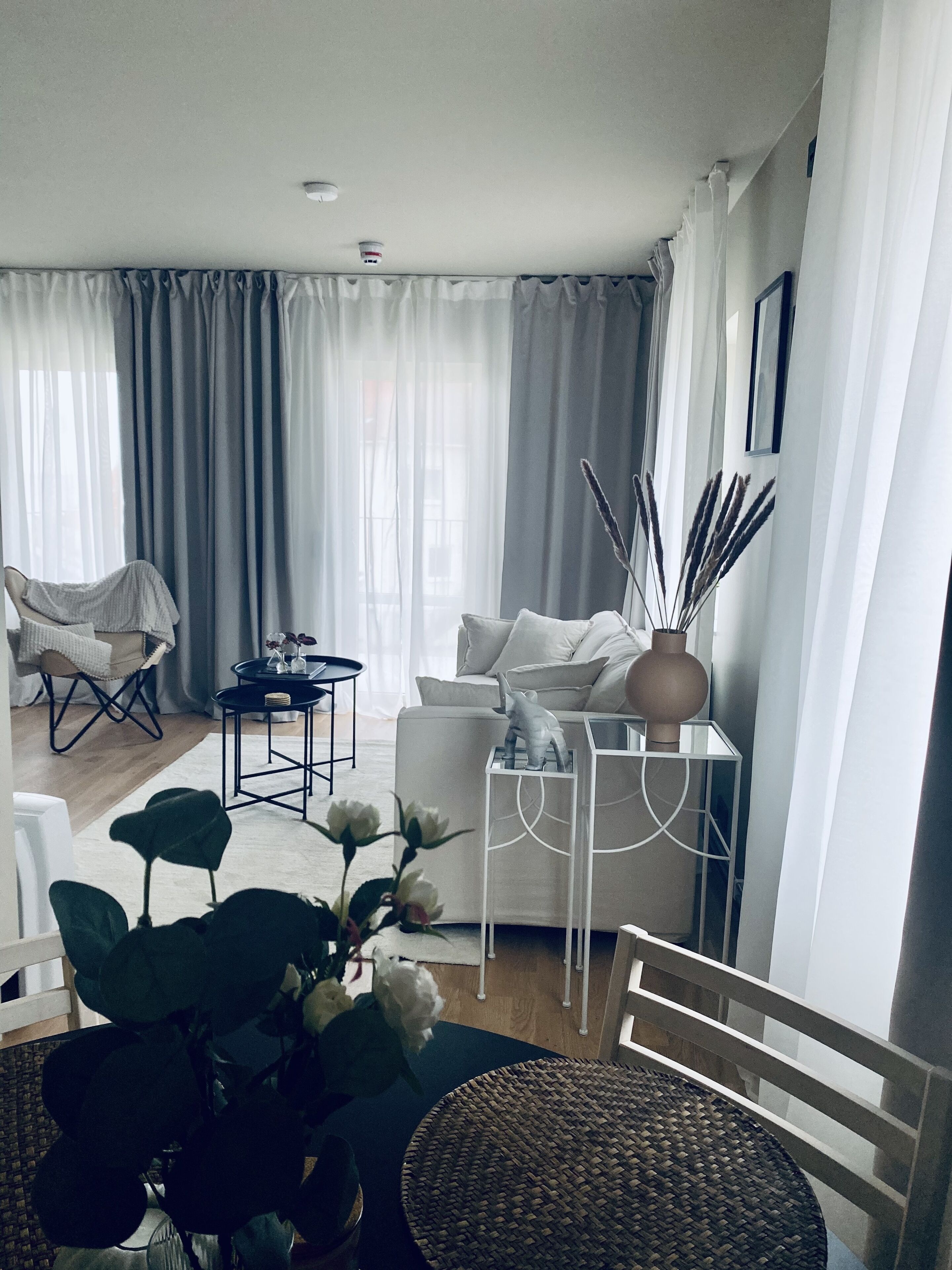 A modern living room with a sofa, coffee table, and dining area.