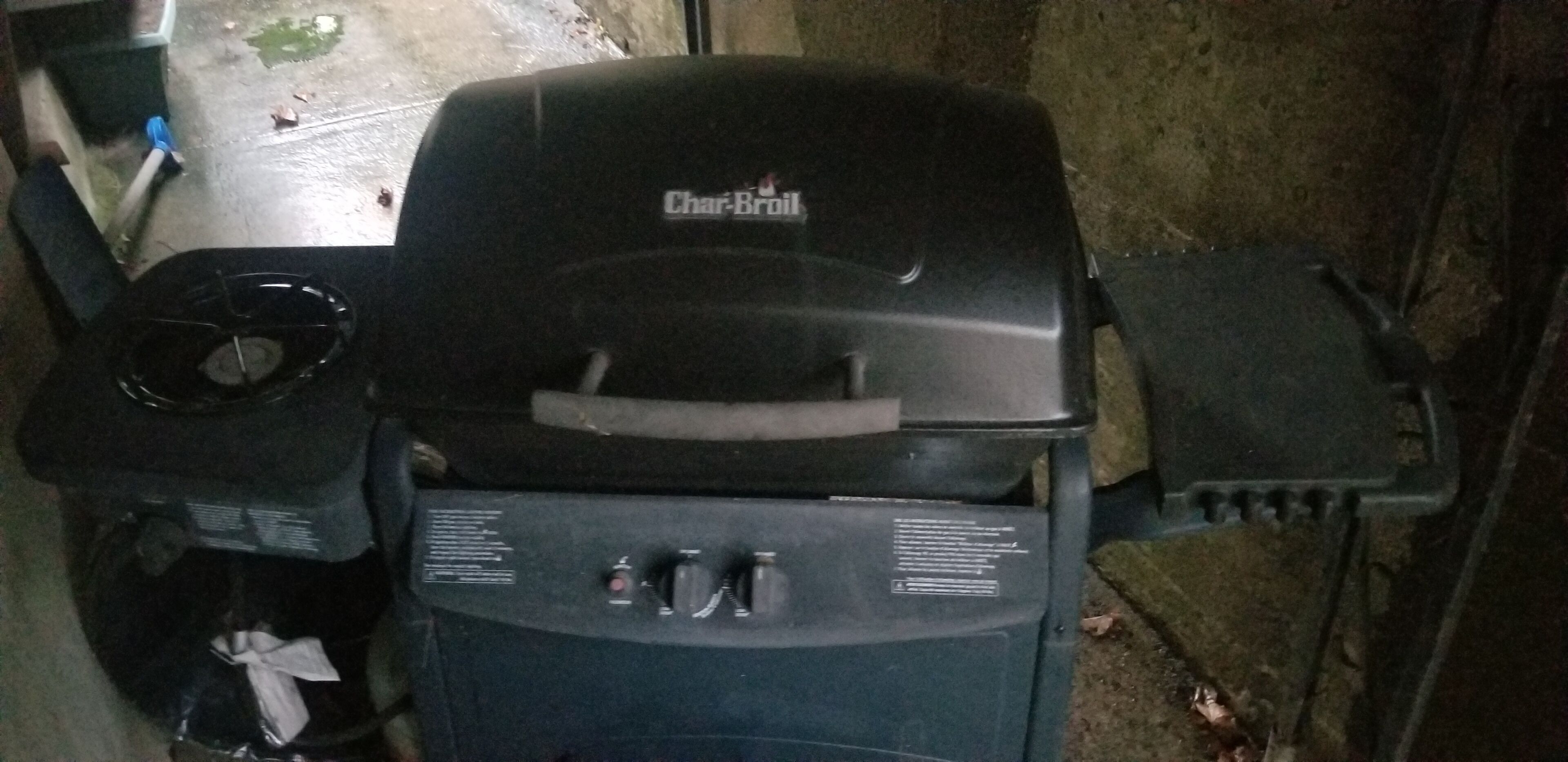 A Char-Broil grill with a control panel and a side burner.