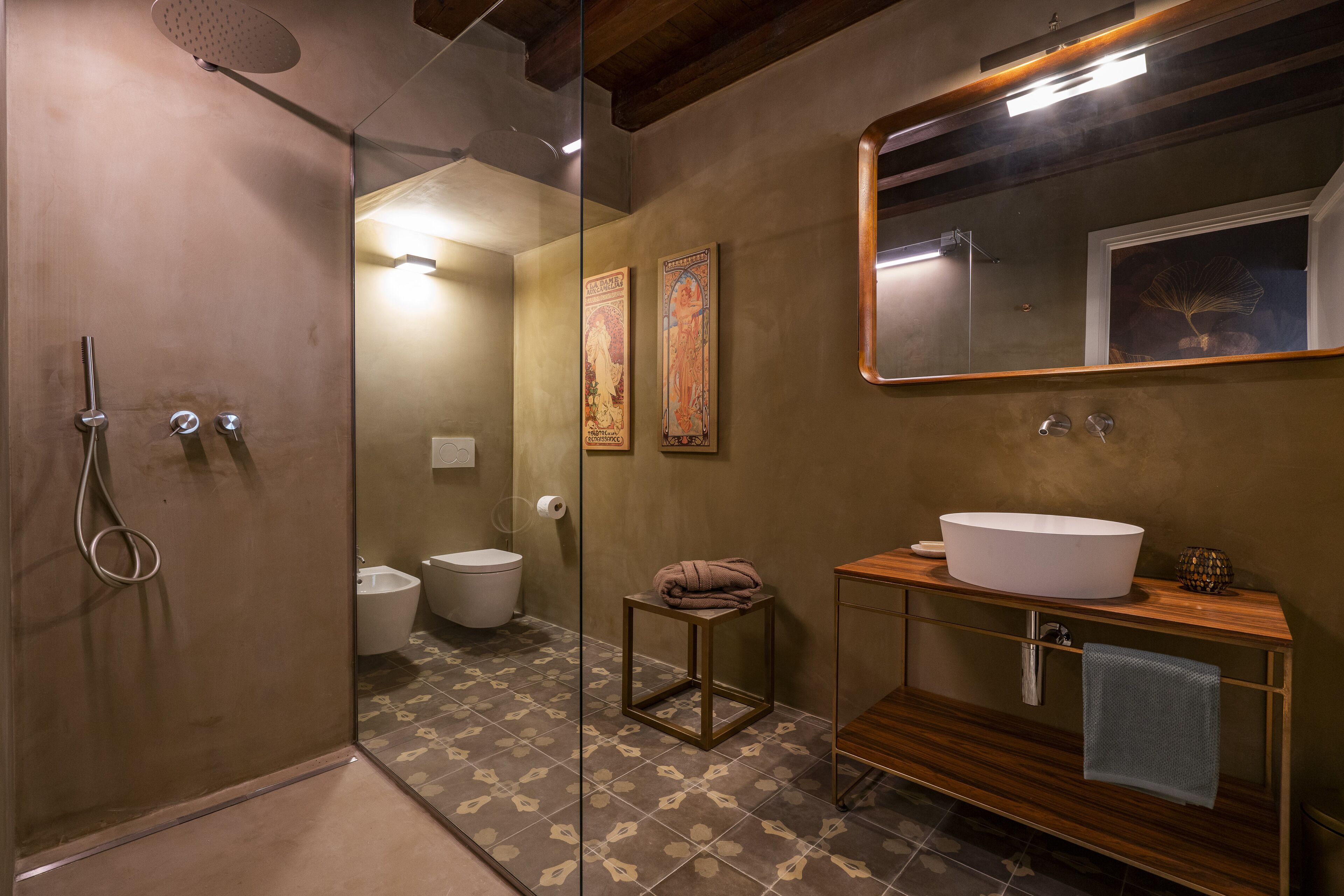 Une salle de bain moderne avec une douche à l’italienne en verre, un meuble-lavabo en bois doté d’un grand évier et un miroir au-dessus du meuble-lavabo.