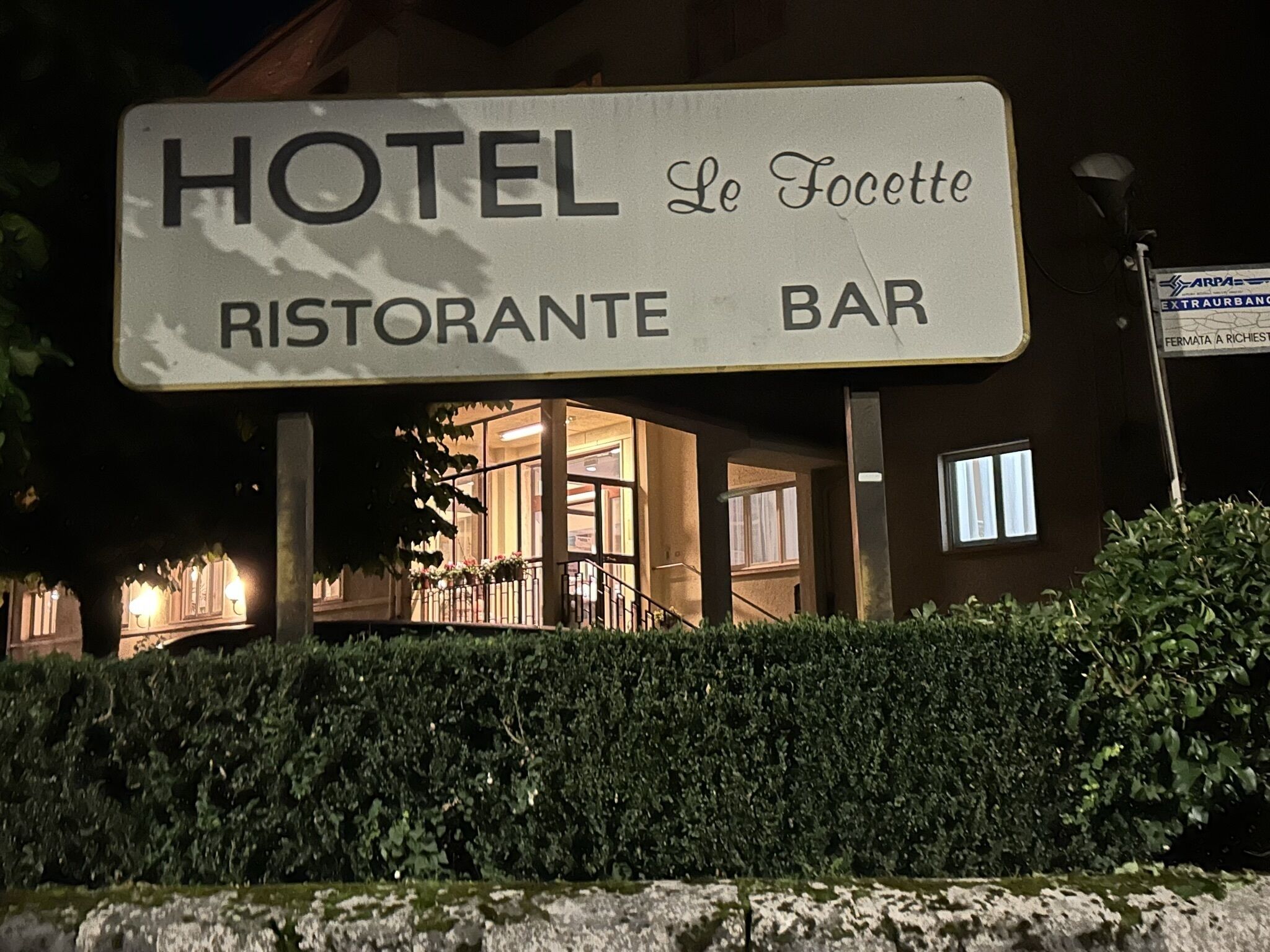 A hotel sign with "HOTEL Le Focette" and "RISTORANTE BAR" indicating a restaurant and bar facility.