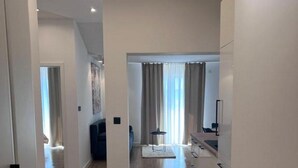 A modern, open-plan living area with a kitchen and dining space.