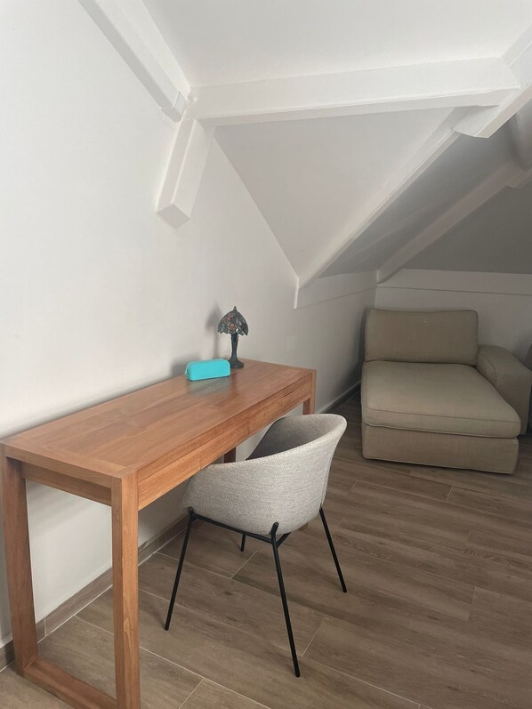 A small, cozy room with a wooden desk, a chair, a lamp, and a sofa. - A Little Paradise on Saint Martin (Grand Case)
