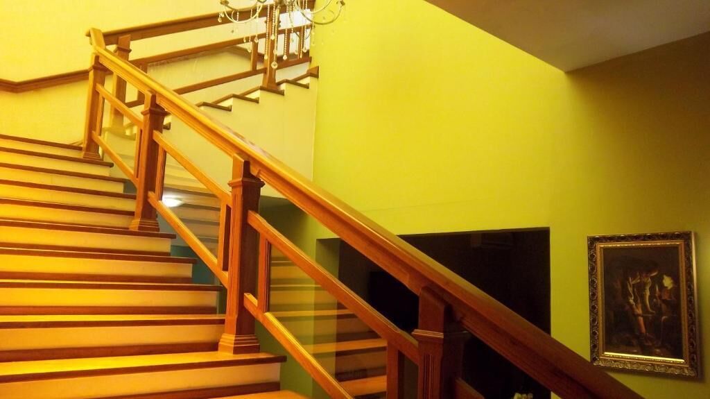A staircase with wooden railings and a chandelier.