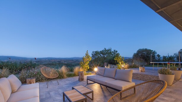 An outdoor patio with a sofa, chairs, and tables, overlooking a scenic landscape. - Villa Ambretta with Private Swimming Pool, Garden and Barbecue (Campagnatico)
