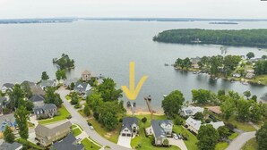 A residential area with houses, a dock, and a lake.
