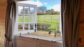 A window with a view of a grassy field and trees. - Arniss - sleeps 20 guests  in 9 bedrooms (Fordingbridge)