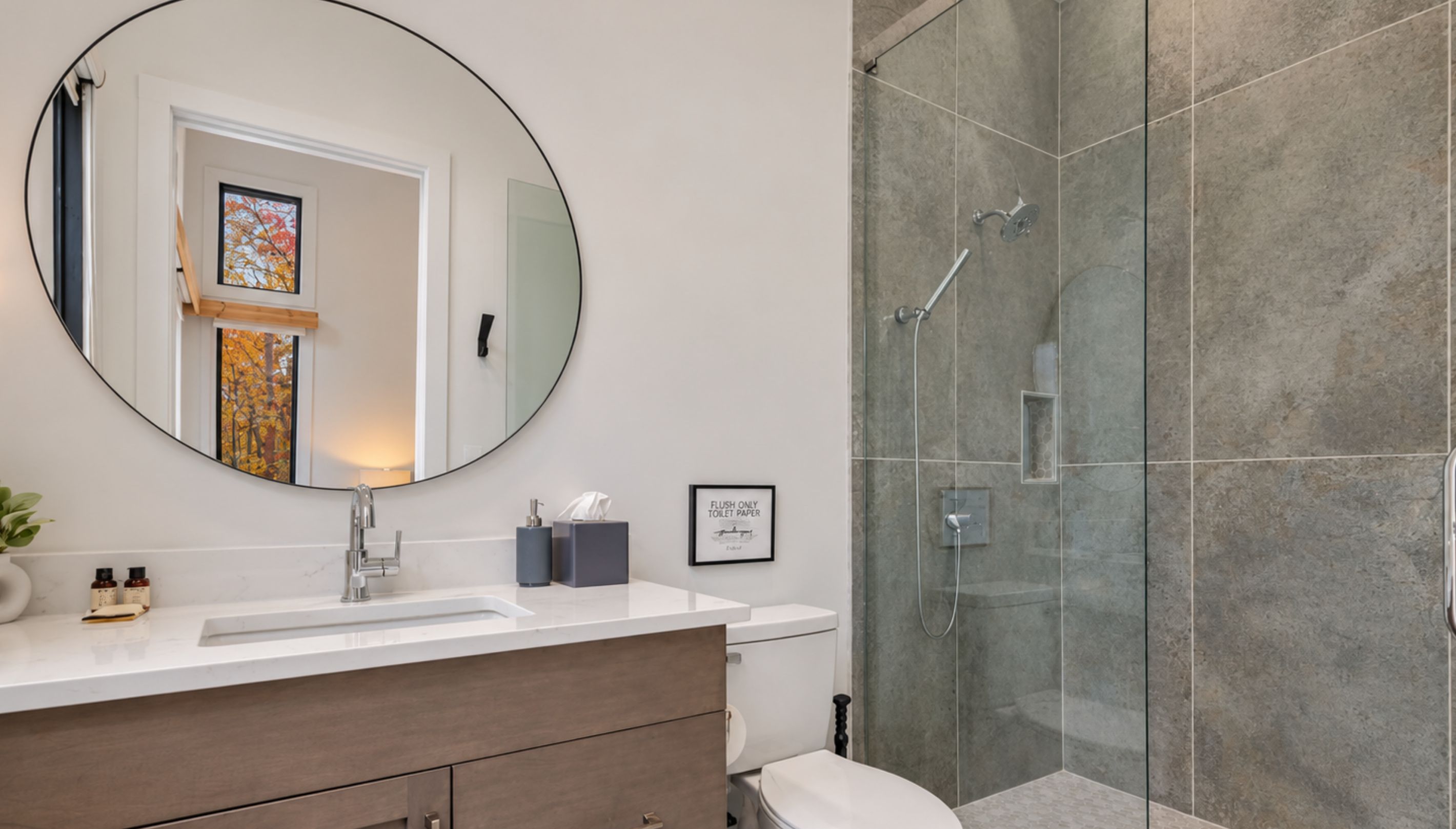 The sleek primary bathroom features a walk-in glass shower and contemporary finishes for a spa-like experience.