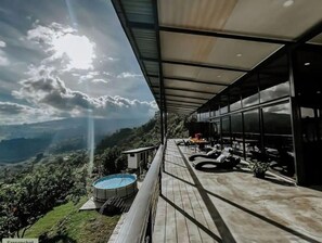 Relax and dine on the spacious outdoor terrace, surrounded by lush greenery and a scenic view.