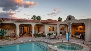A pool area with a hot tub, outdoor seating, and a patio with umbrellas. - Casa Del Lobo - Private Spanish Oasis Getaway (Palm Springs)