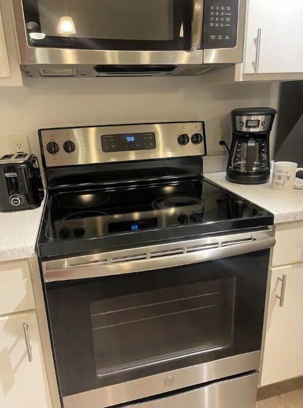 Enjoy cooking in this well-equipped kitchen with a microwave, coffee maker, and oven.