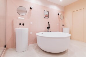 Bathtub, hair dryer, towels, shampoo