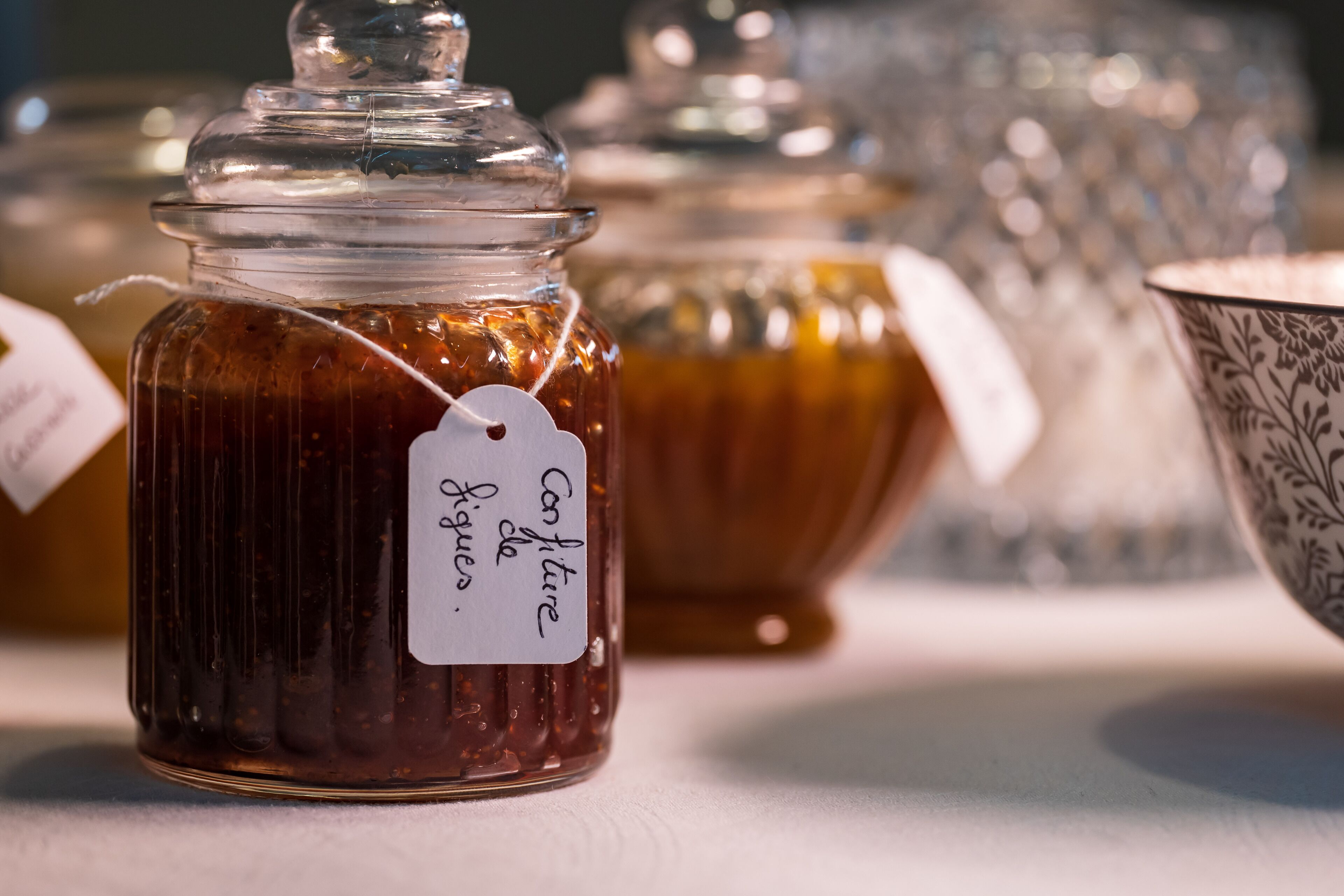 A jar with a tag labeled "Confiture de Figues."