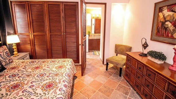 A bedroom with a bed, a dresser, a chair, and a wardrobe. - Tropical retreat with beautiful pool and yard (San Miguel de Cozumel)