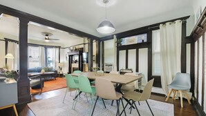 A dining area with a table, chairs, and a ceiling fan. - Newly Updated 3BR Furnished Home Close to Path, Lightrail and Pets Welcome (Jersey City)