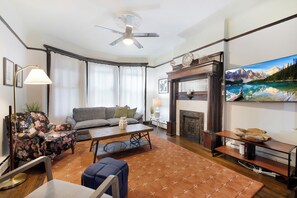 Relax in a cozy living room with a comfortable sofa, wooden coffee table, and a fireplace.