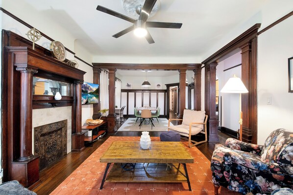 Relax in this elegantly furnished living room with a comfortable sofa, coffee table, and classic fireplace.