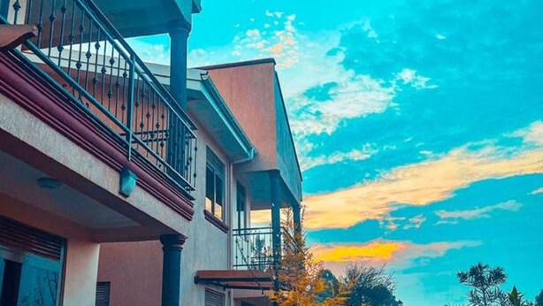 A multi-story building with a balcony and a staircase. - Nataaha Hotels (Mbarara)