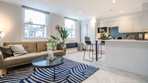 Luxe appartement, 1 tweepersoonsbed met slaapbank, uitzicht op de stad | Woonruimte | Een 42-inch flatscreentelevisie met satellietzenders en televisie