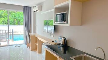 Deluxe Double Room, Pool Access | Individually furnished, desk, laptop workspace, soundproofing
