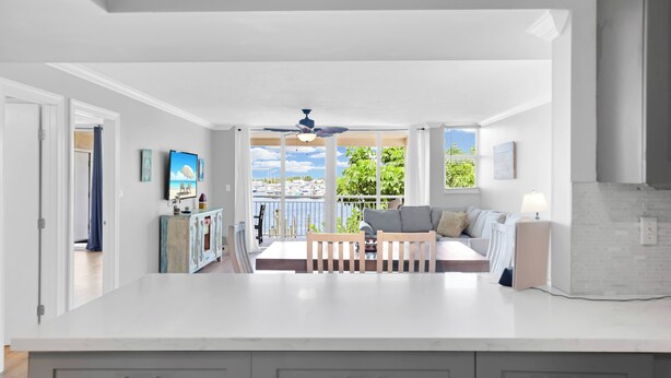 A spacious kitchen with a large island, a dining area with a view, and a balcony with a view. - Waterfront Dock Pool Key West Near Duval (Key West)