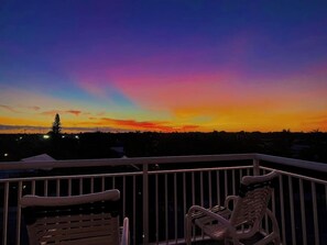 A balcony with two white plastic chairs and a railing. - Penthouse Waterfront Dock Pool Condo Near Duval St (Key West)