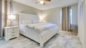 A bedroom with a bed, nightstand, lamp, ceiling fan, and a chair. - 7 Mi to Dtwn: Little Rock Home Near Interstate (Little Rock)