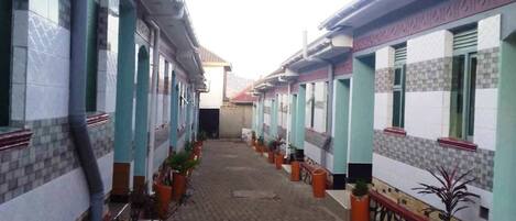 A corridor with tiled walls and potted plants.