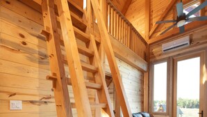 A wooden interior with a staircase, a sofa, and a ceiling fan. - #17 Wood Duck Way (Dahinda)