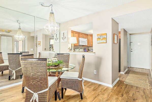 Enjoy meals in this stylish dining area with a glass-top table and comfortable wicker chairs.