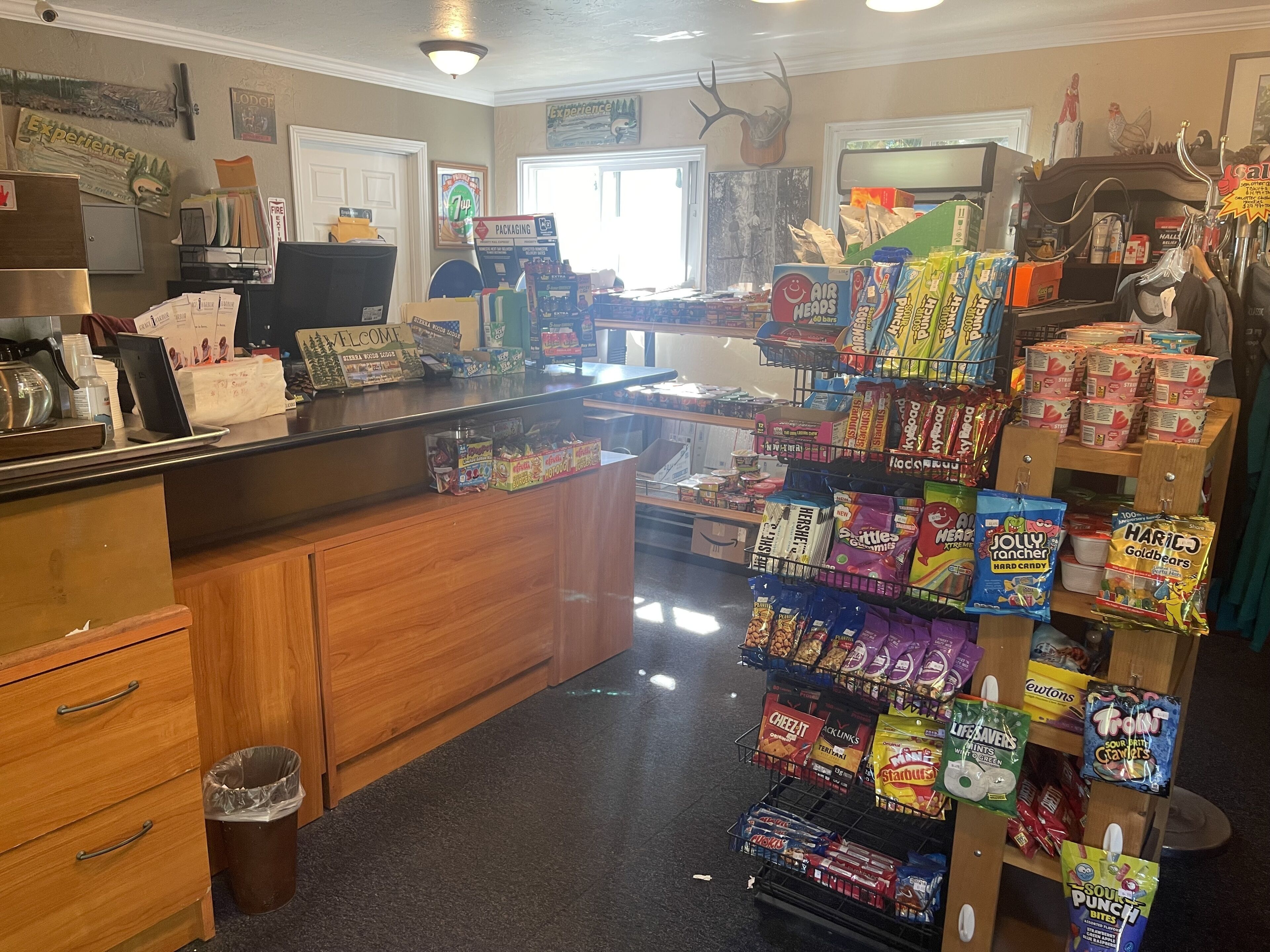A store with a counter, various snacks, and a sign that says "PACKAGING".