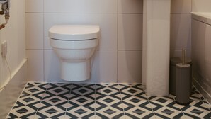 A bathroom with a toilet, a sink, and a mirror. - York Riverside Apartments are 11 beautiful, modern, and stylish apartments based in the centre of Hi (York)