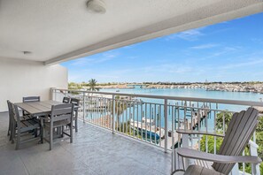 A balcony with a view of a marina and a body of water.