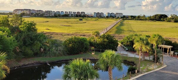 A coastal residential area with a long bridge connecting two parts of the property, surrounded by lush greenery and a calm water body. - ** Prime 3Br/2Ba Beach Villa at Hilton Head Resort ** (Hilton Head Island)