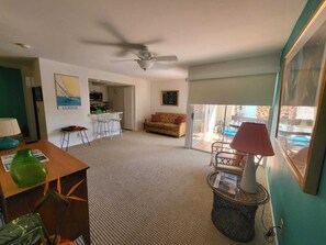 Cozy living space with a dining area and sofa, offering a view of the outdoors.