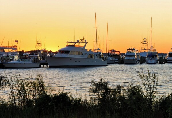 A marina with multiple yachts docked at sunset. - Sandestin Resort - Golf Cart Included - Sleeps 6 (Destin)