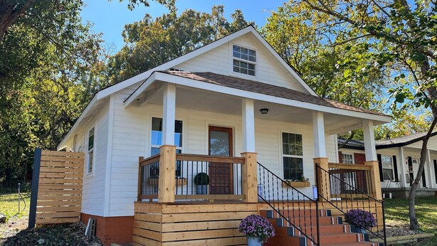 A single-story house with a front porch, wooden steps, and a small garden area with flowers. - The Archer House - 1 Block from Spring River.  2 Bedrooms + Loft Bedroom!   (Mammoth Spring)
