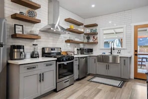Enjoy cooking in this well-equipped kitchen with a stove, oven, and dishwasher.